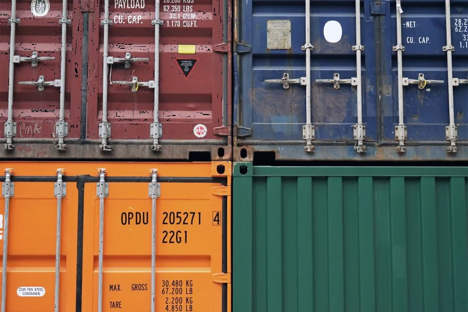 Conteneurs de marchandises empilés sur une plateforme logistique.